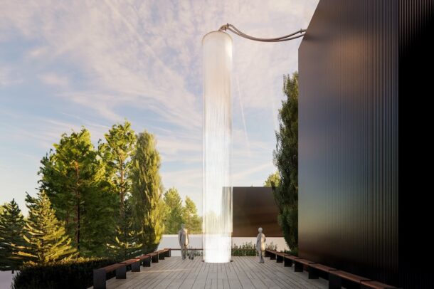 Modern courtyard with tall cylindrical light sculpture.